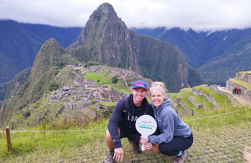 Tourist couple visiting Machu Picchu